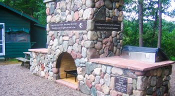 Clearwater camp outdoor stone fireplace with memorial plaques