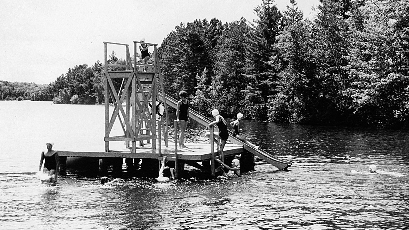 Black and white photo of 1965 campers on camp diving platform