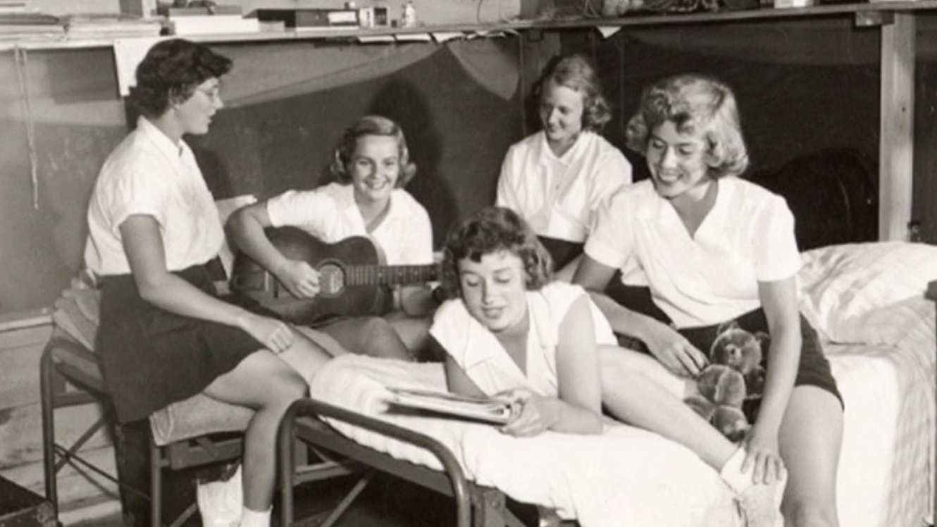 Black and white photo of campers playing music