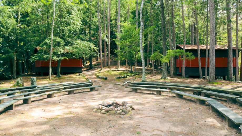 Clearwater Camp firepit with cabins visible behind
