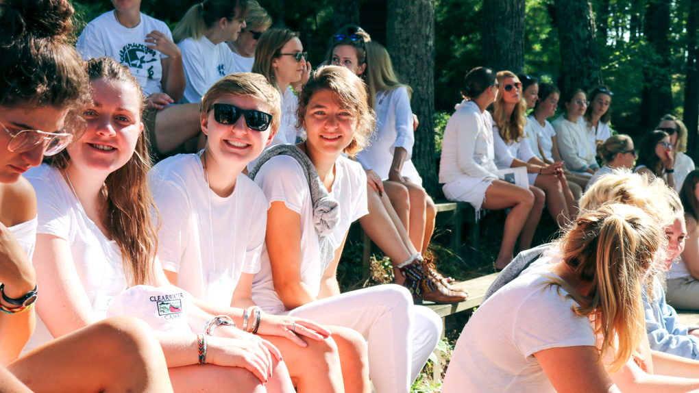 Campers smile from audience of Sunday Service