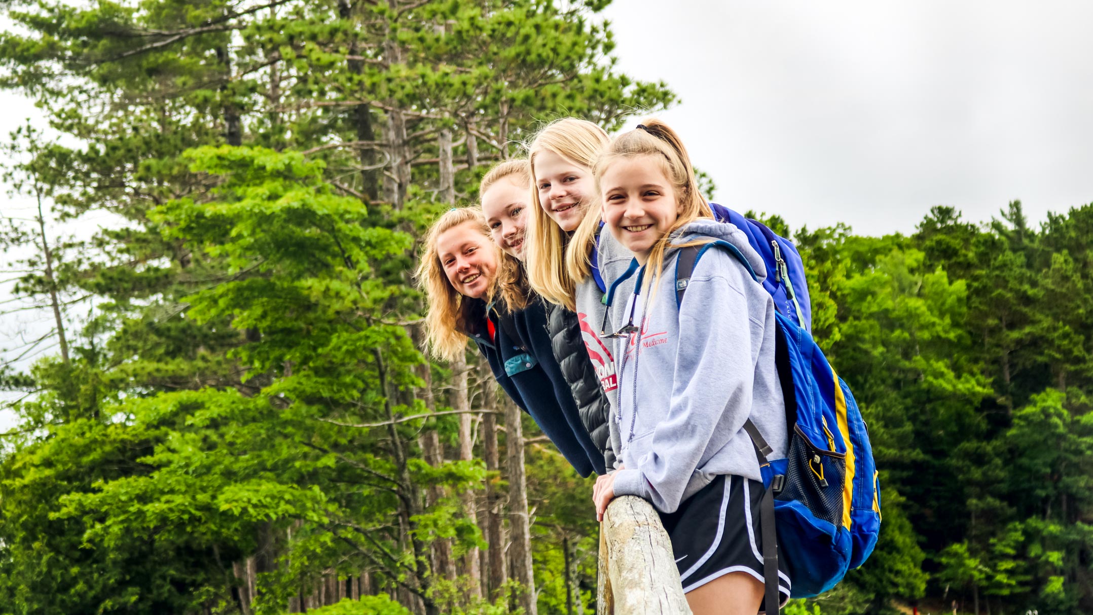 Campers lean out over bridge railing