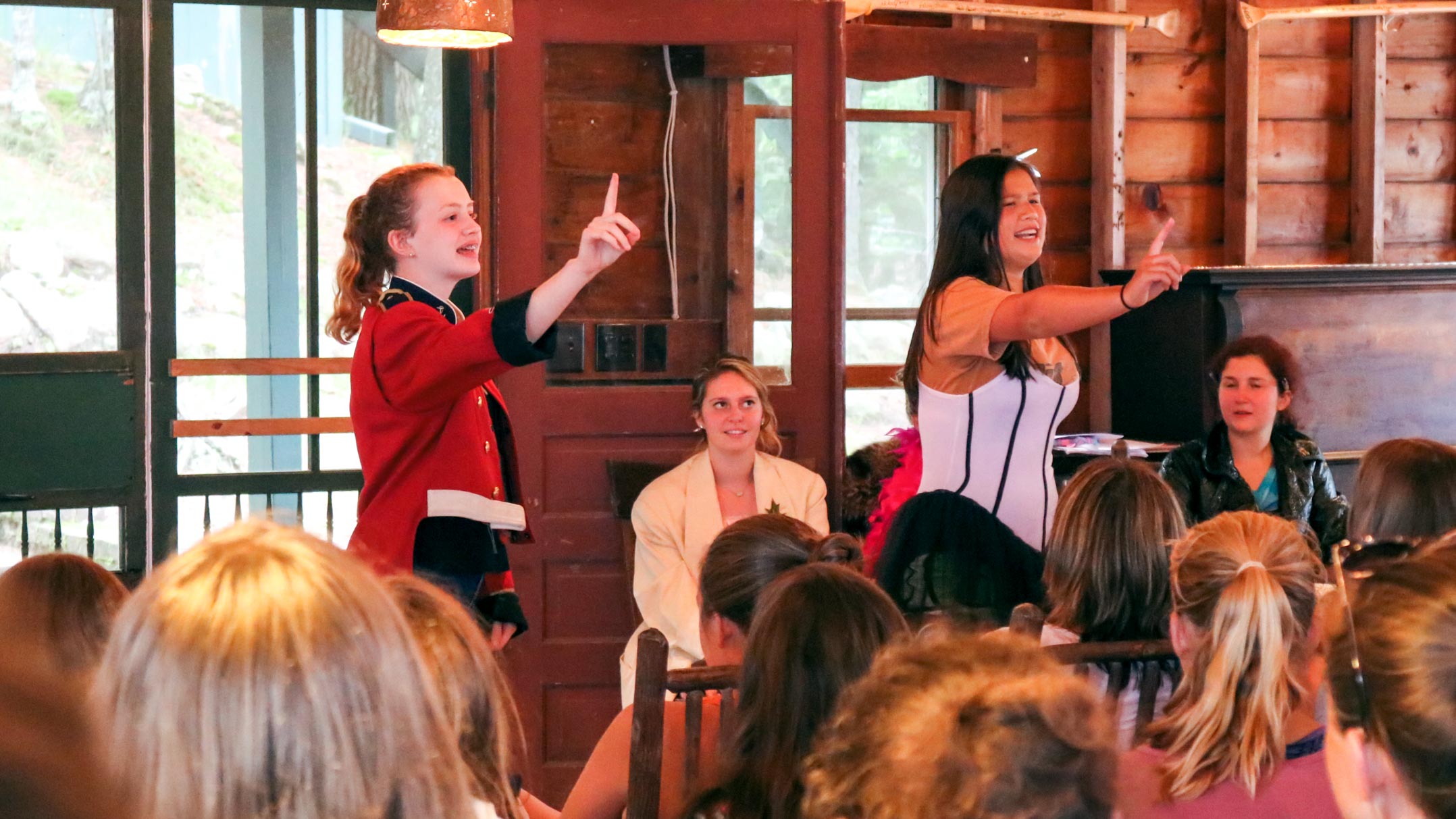 Two girls perform in costume at camp talent show