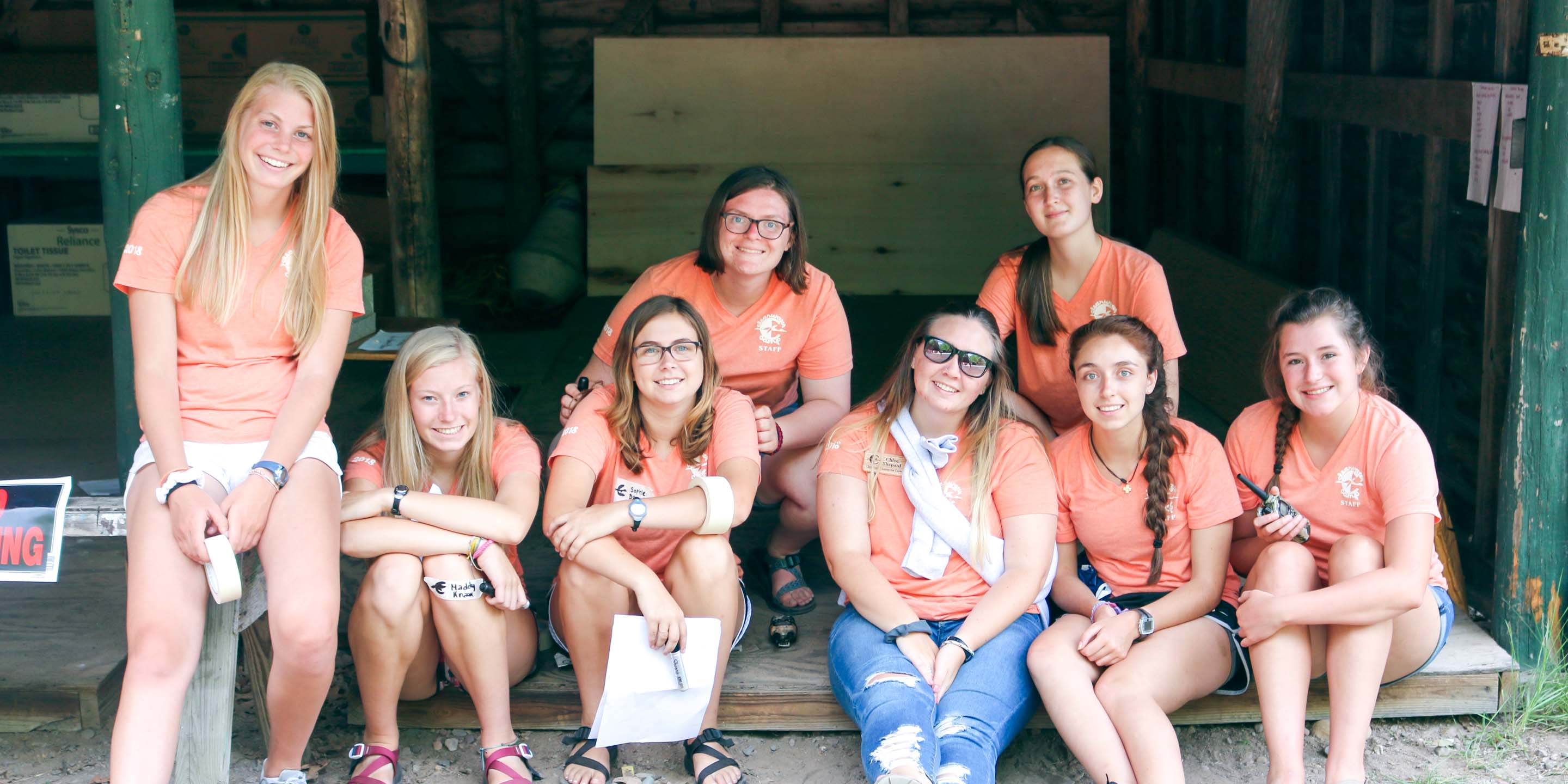 Group of leaderships sit in camp shed